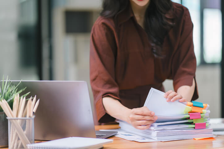 An accounting clerk organizing financial records in an office setting