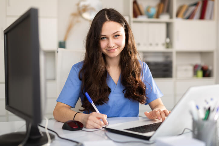 A student learning administrative tasks in a medical office assistant program