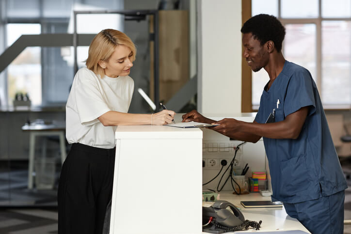 A student practicing administrative skills in a medical office setting