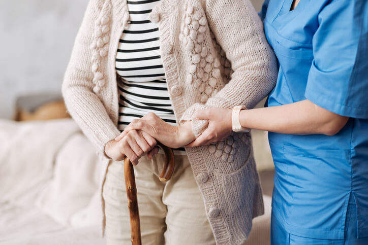 A healthcare assistant supporting a patient in a BC healthcare facility